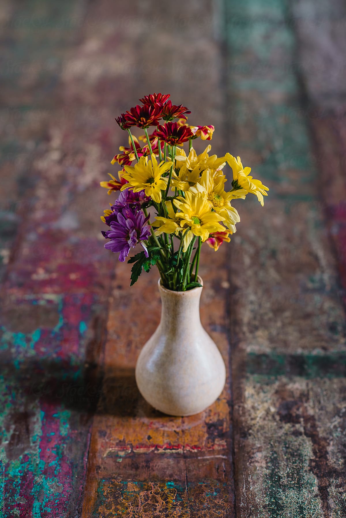 Flowers In  Ceramic Vase On Old Table