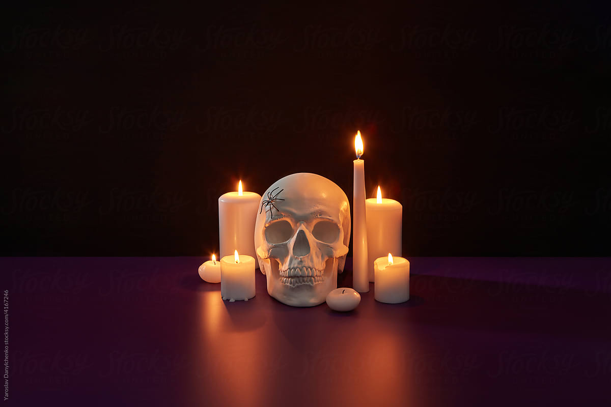 Spooky skull with spider and burning candles
