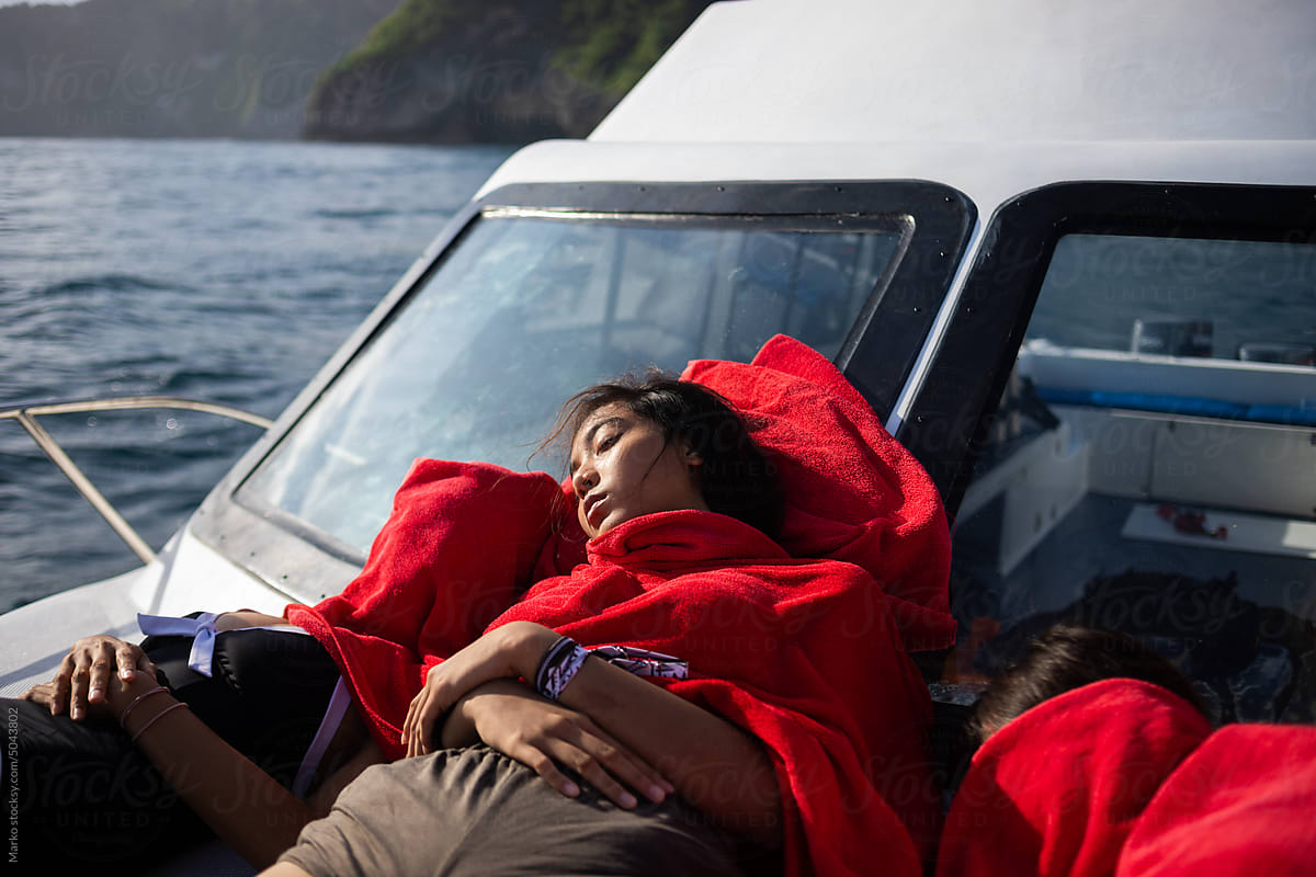 Girls sleeping at boat sunbathing