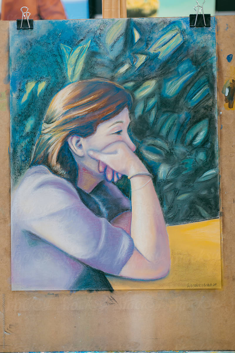 Pastel artwork on canvas on easel of sad woman