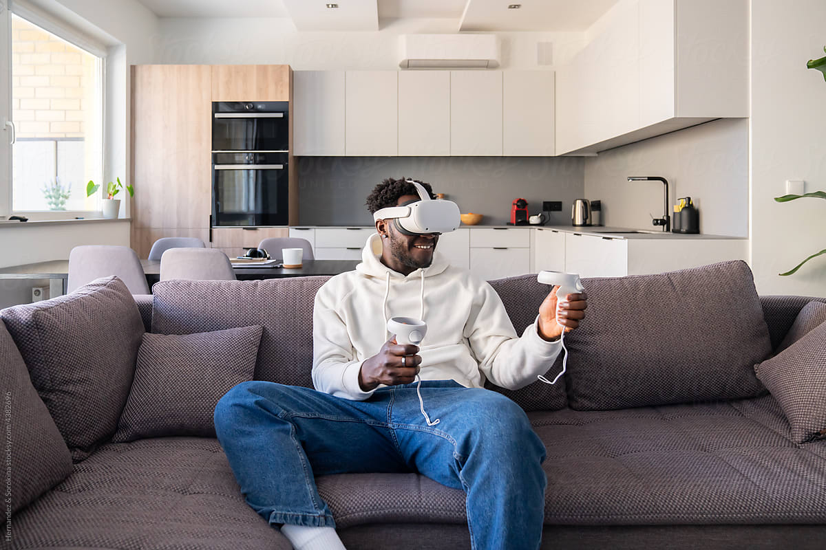 Man Wearing Virtual Reality Glasses At Home