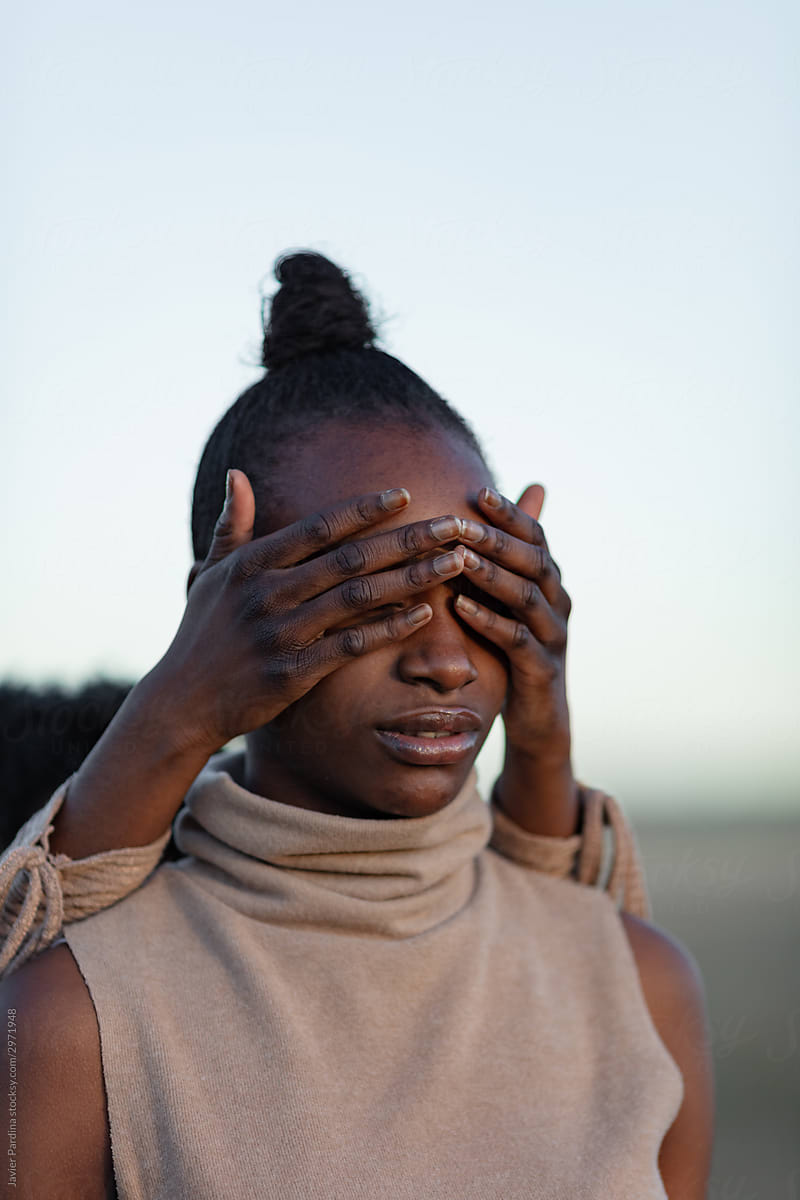African Woman covering eyes