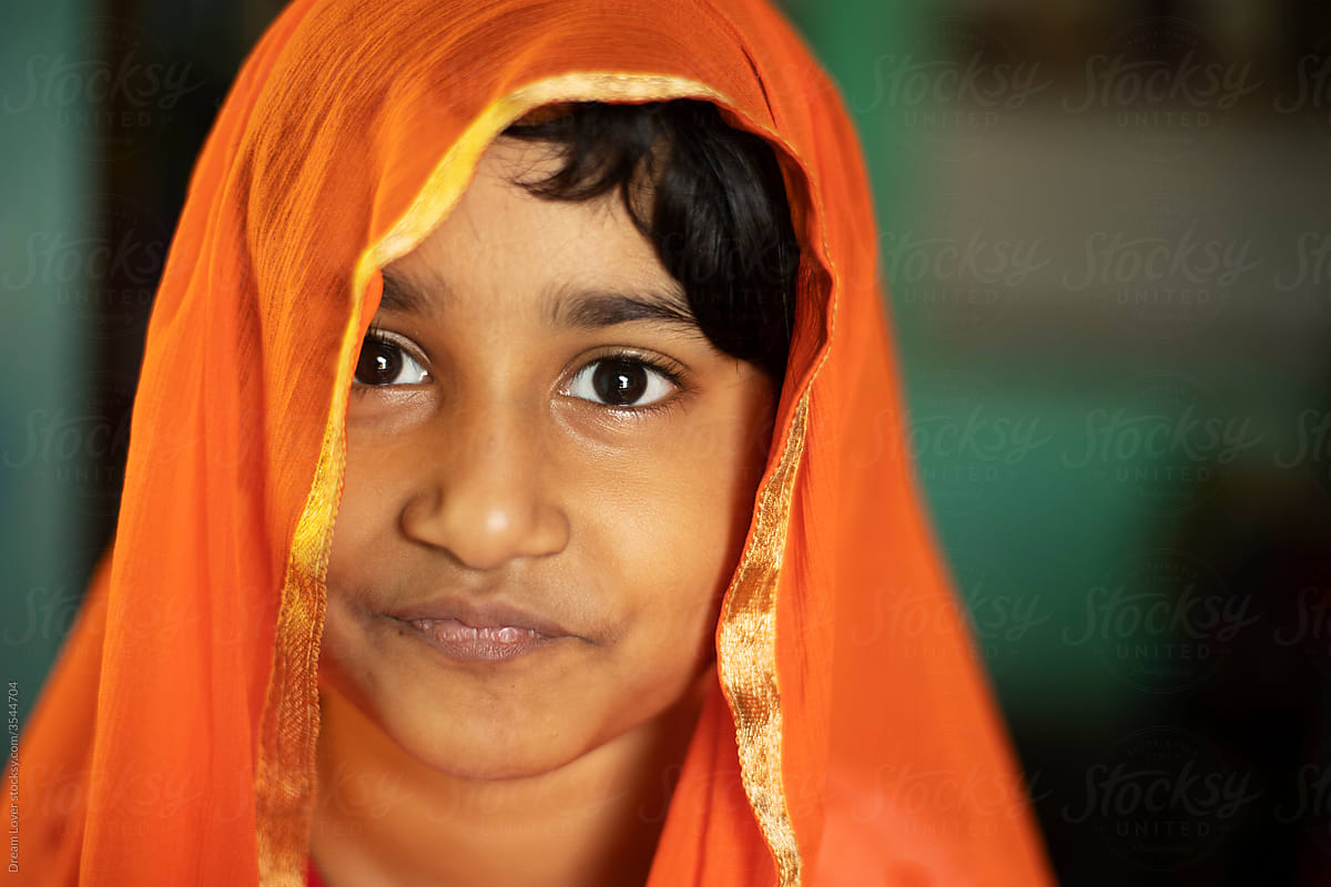 Closeup portrait of a cute Indian girl wearing veil on head