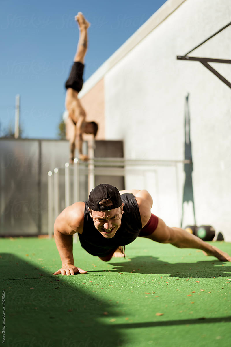 Push-up and handstand. Calisthenics training outdoor.