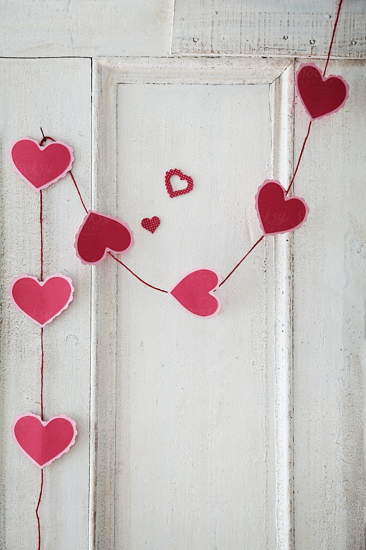 Garland of paper hearts on old door