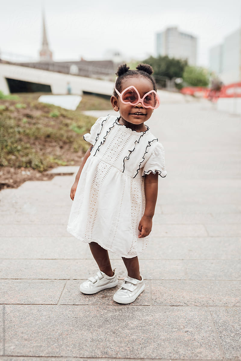 Toddler girl in white dress and shoes