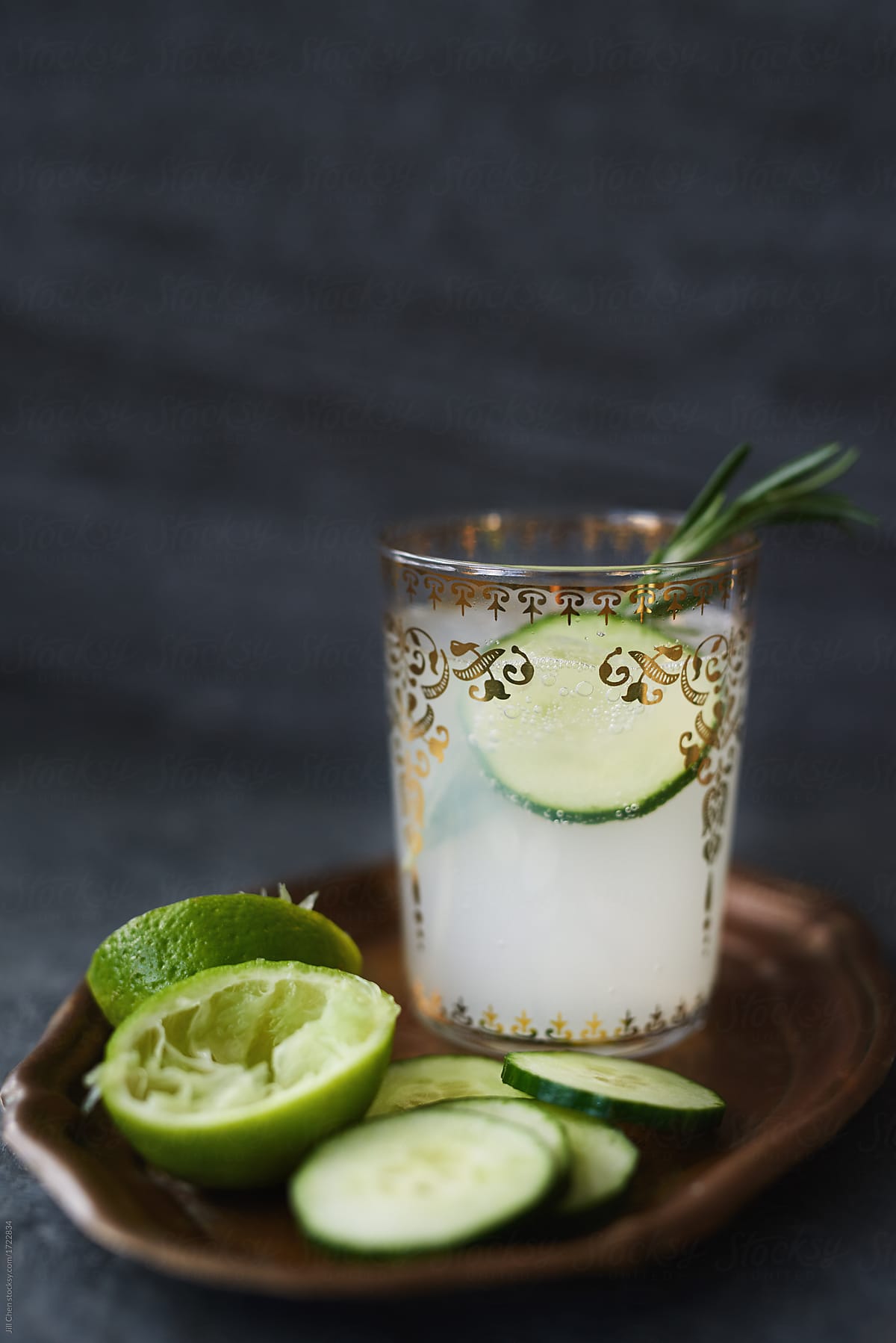 Lime juice with cucumber and rosemary on dark background