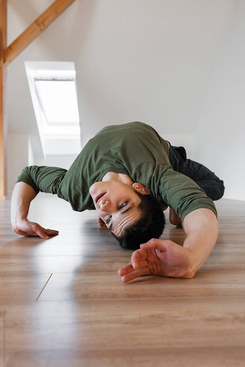 Flexible male dancing on floor