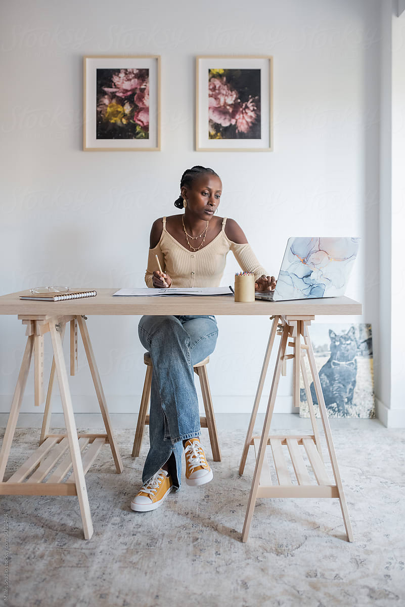 Black female architect using laptop