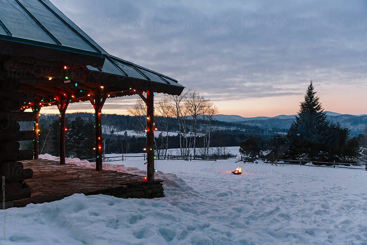 Porch of Log Cabin in Vermont Landscape  with Winter Christmas Lights