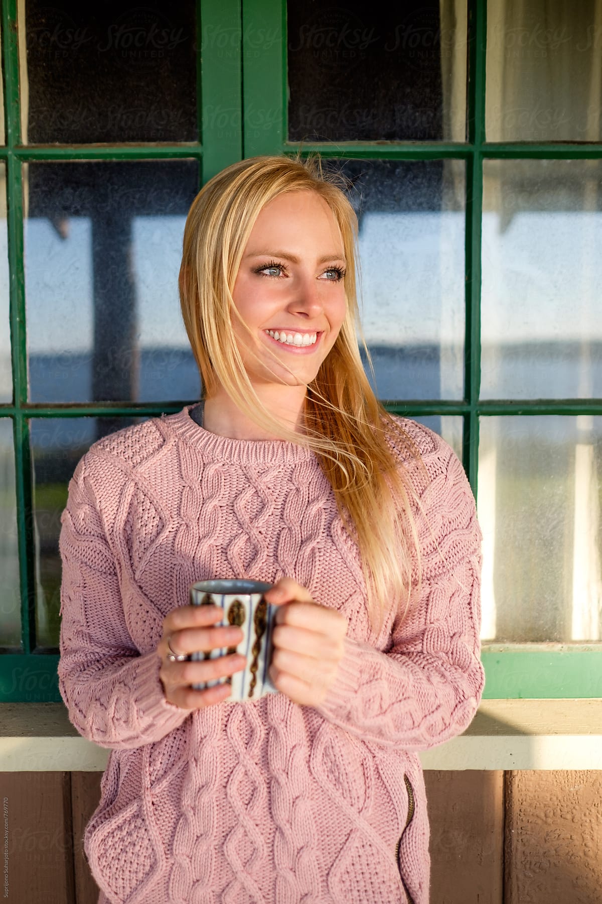 Happy beautiful woman holding a cup of coffee