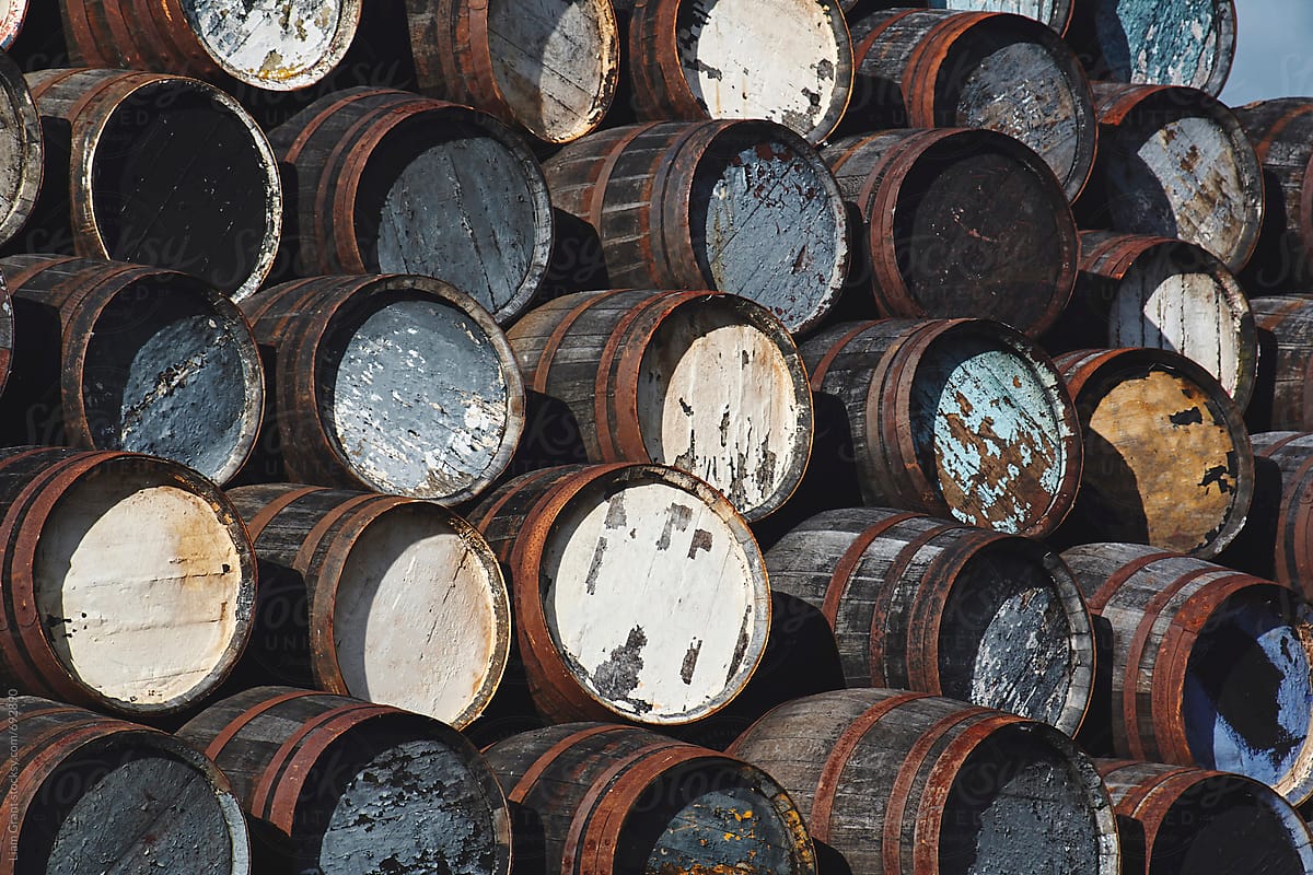 A pile of old whiskey casks stored outside. Scotland.