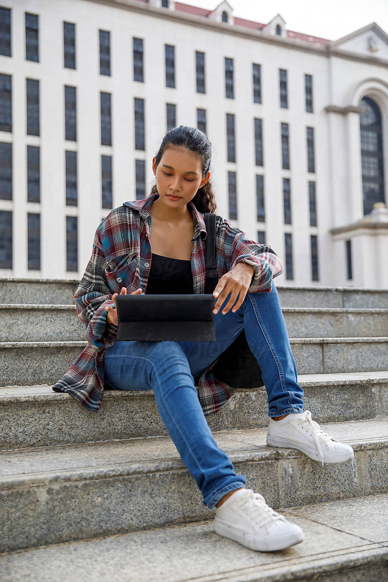 Student using digital tablet at university campus