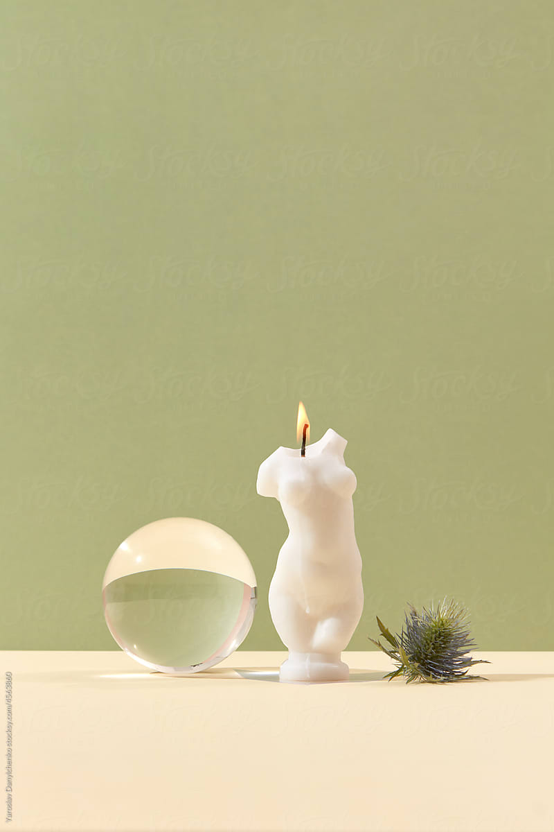 Female torso candle and glass ball