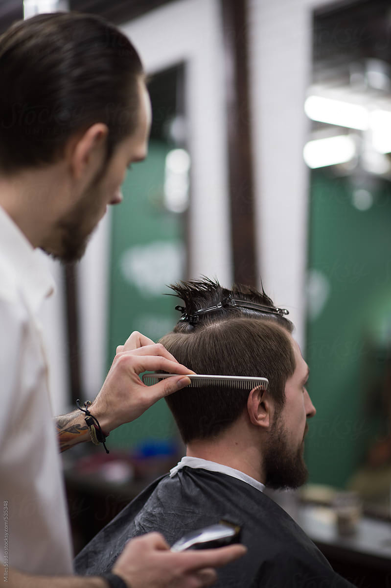 Barber Cutting Hair to a Client