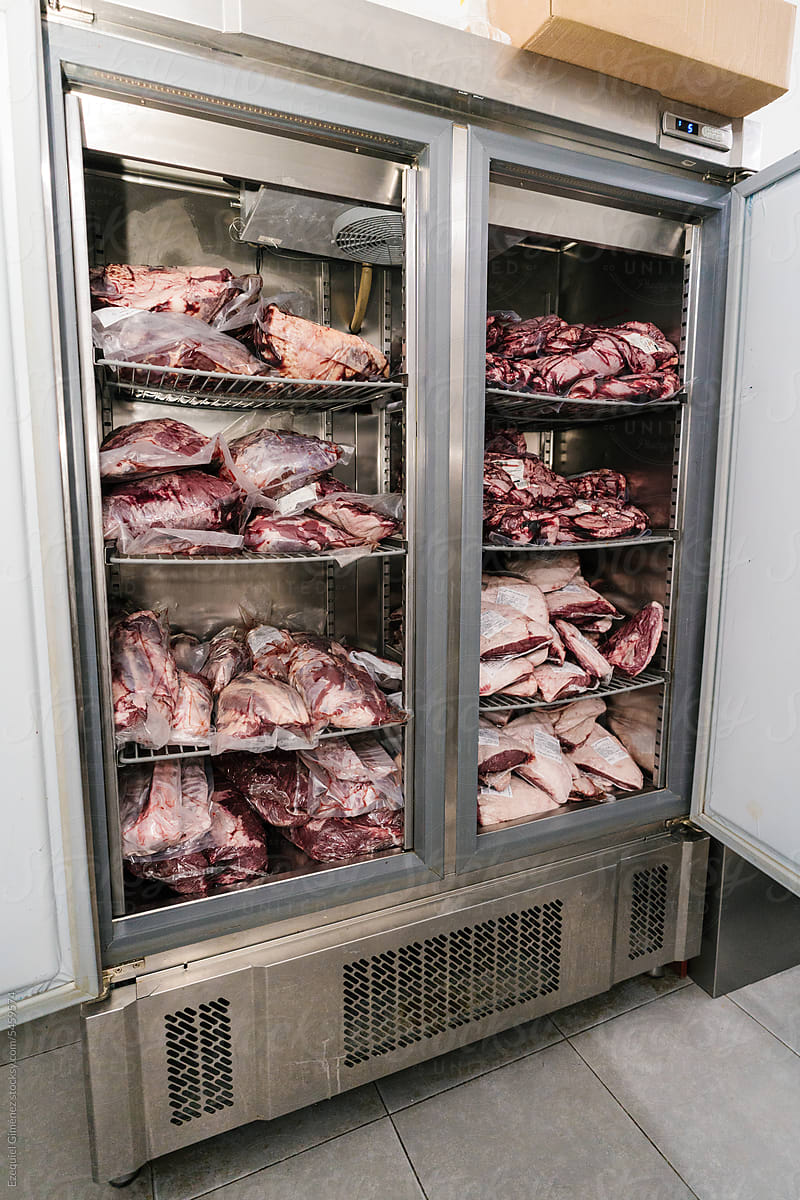 Pieces of raw meat in fridge in butchery
