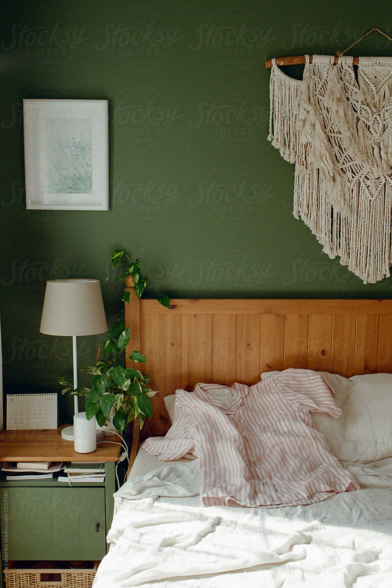 A Part View Of A Bedroom with green Wall