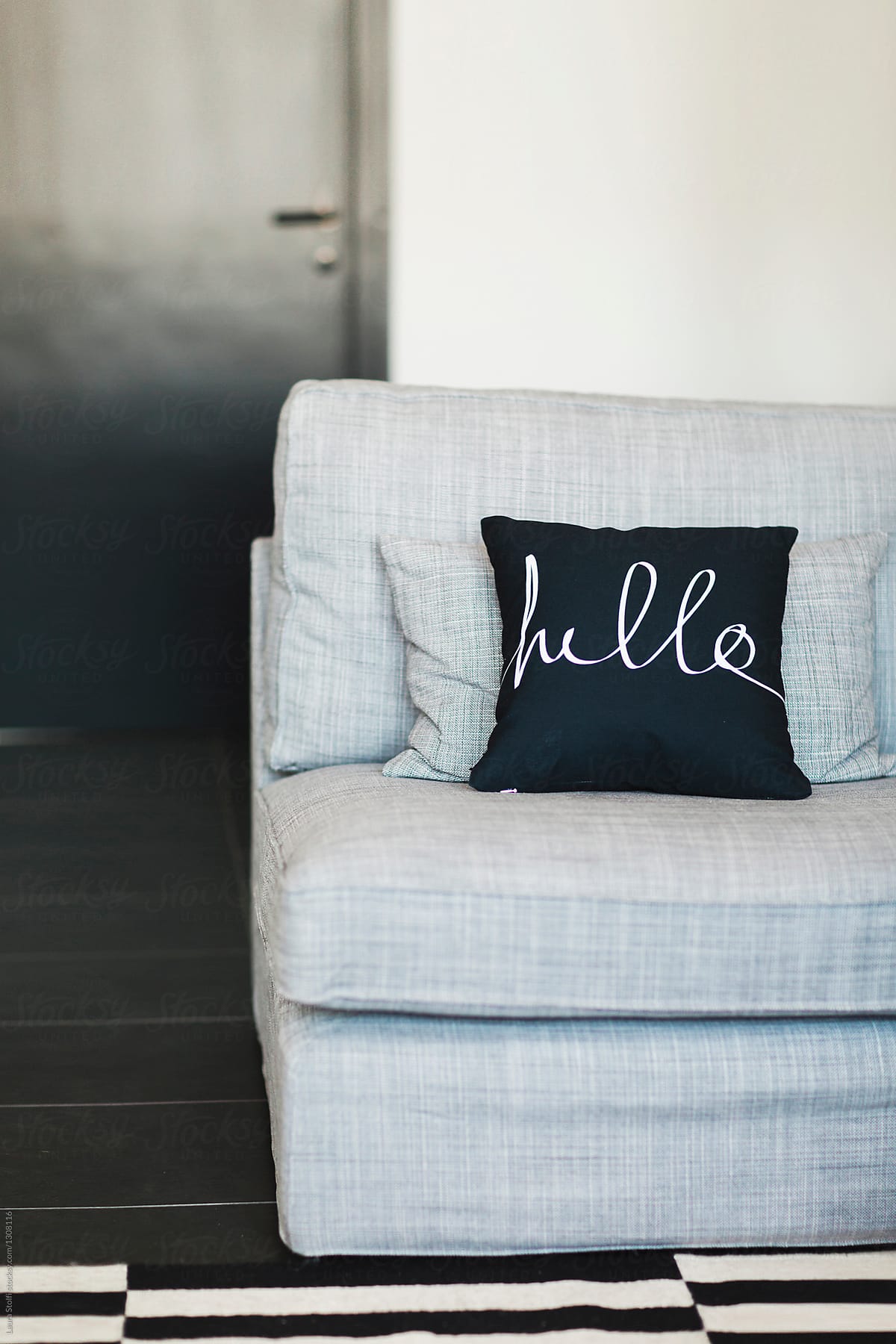 Cushion spelling the word Hello on sofa