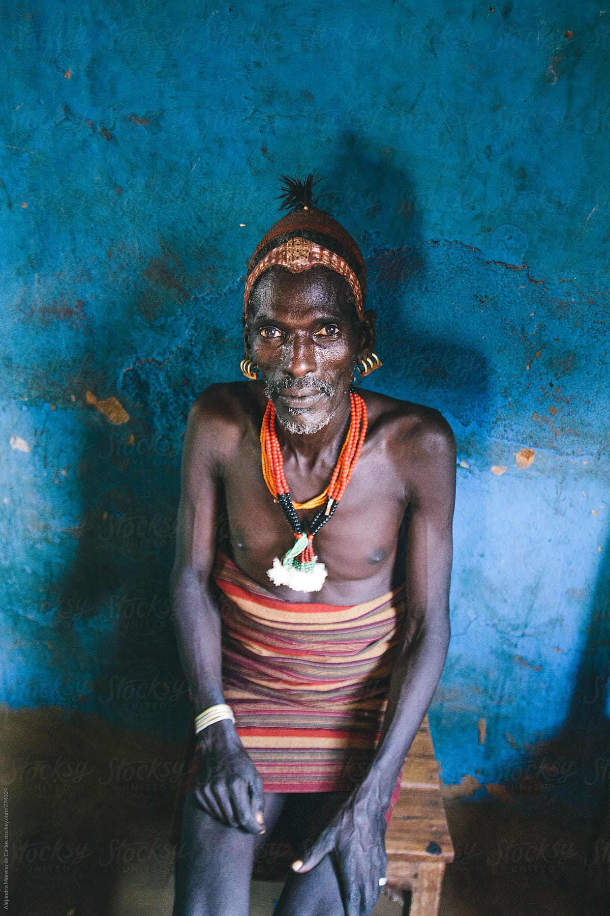 Hamer tribe senior man portrait with traditional clothes on a local bar. Omo Valley, Ethiopia