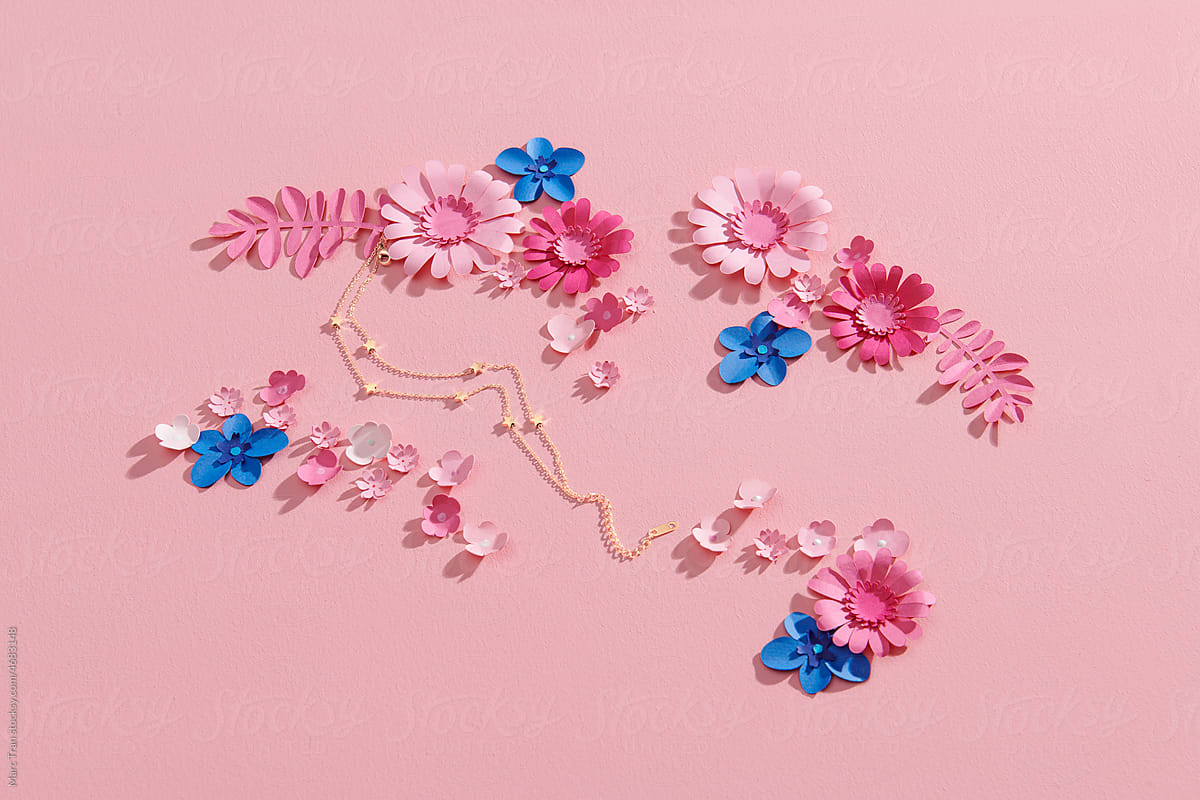 Beautiful flowers and branches made of paper on pink background