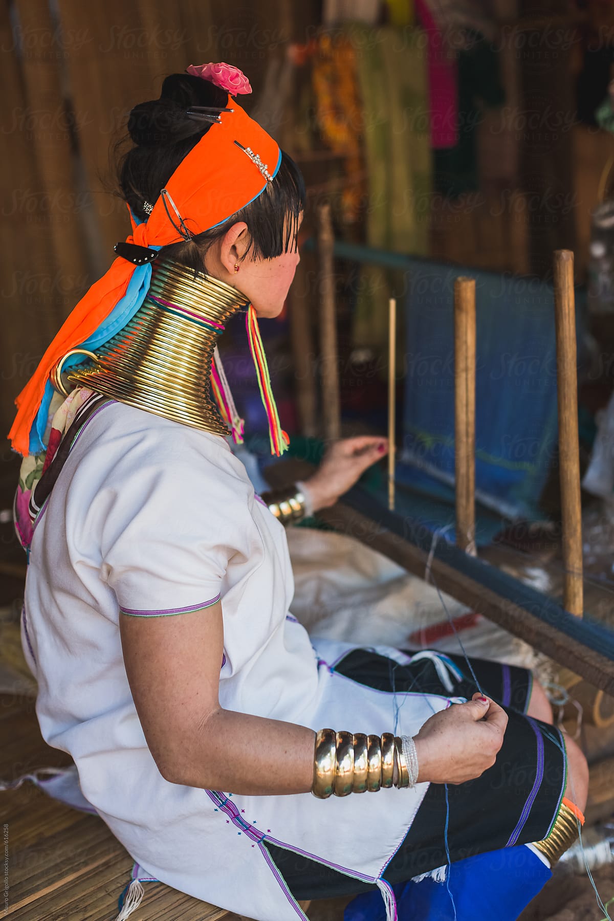 A Long Neck woman working on the loom to produce silk dresses