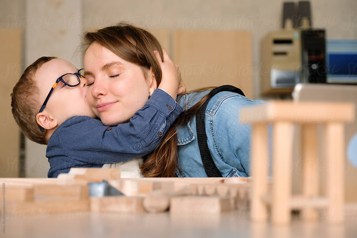 Little kid kissing mom during game together