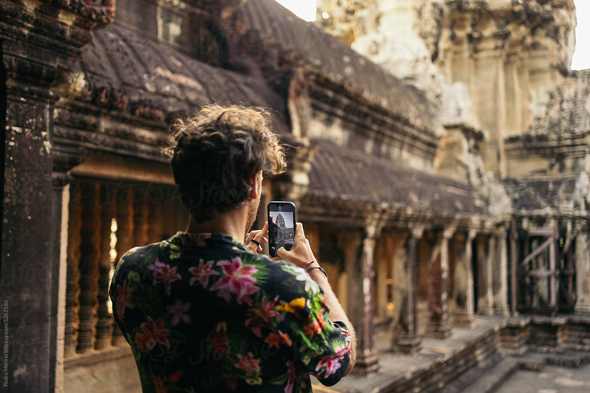 Tourist taking photos in Angkor Wat temple