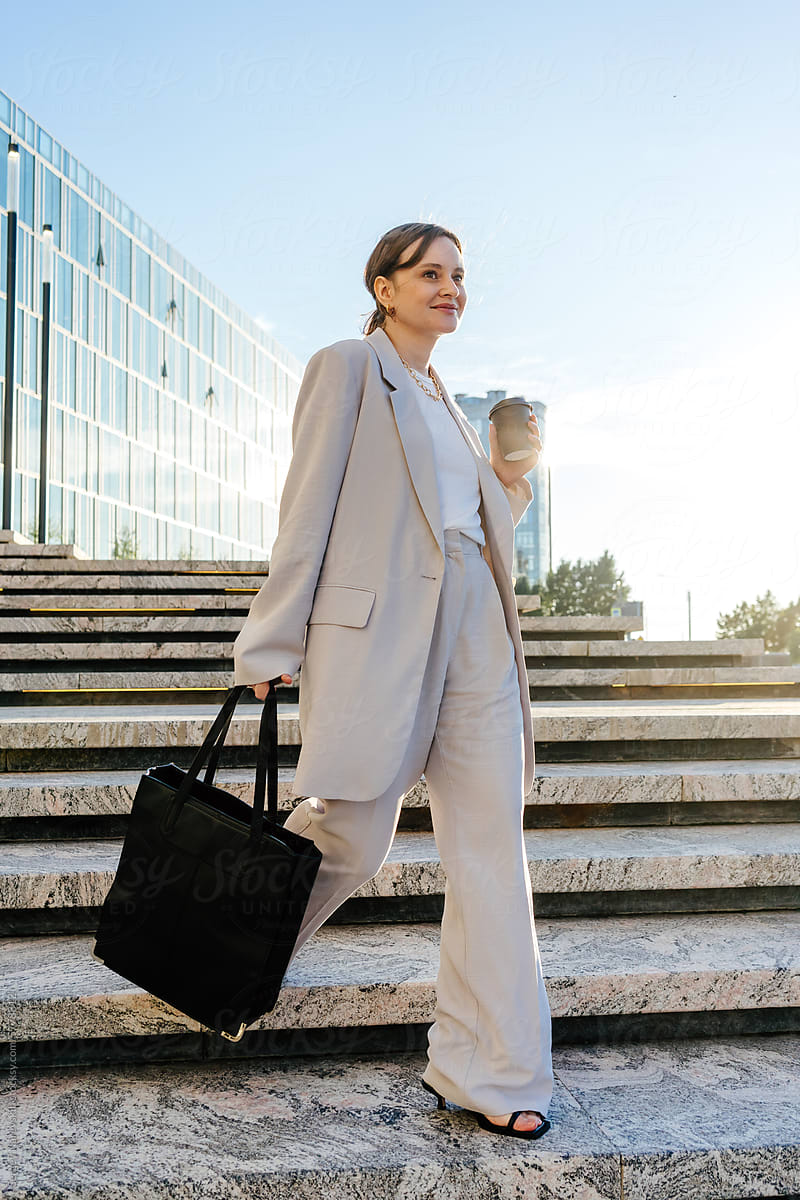 Confident woman with coffee and bag, coffee break