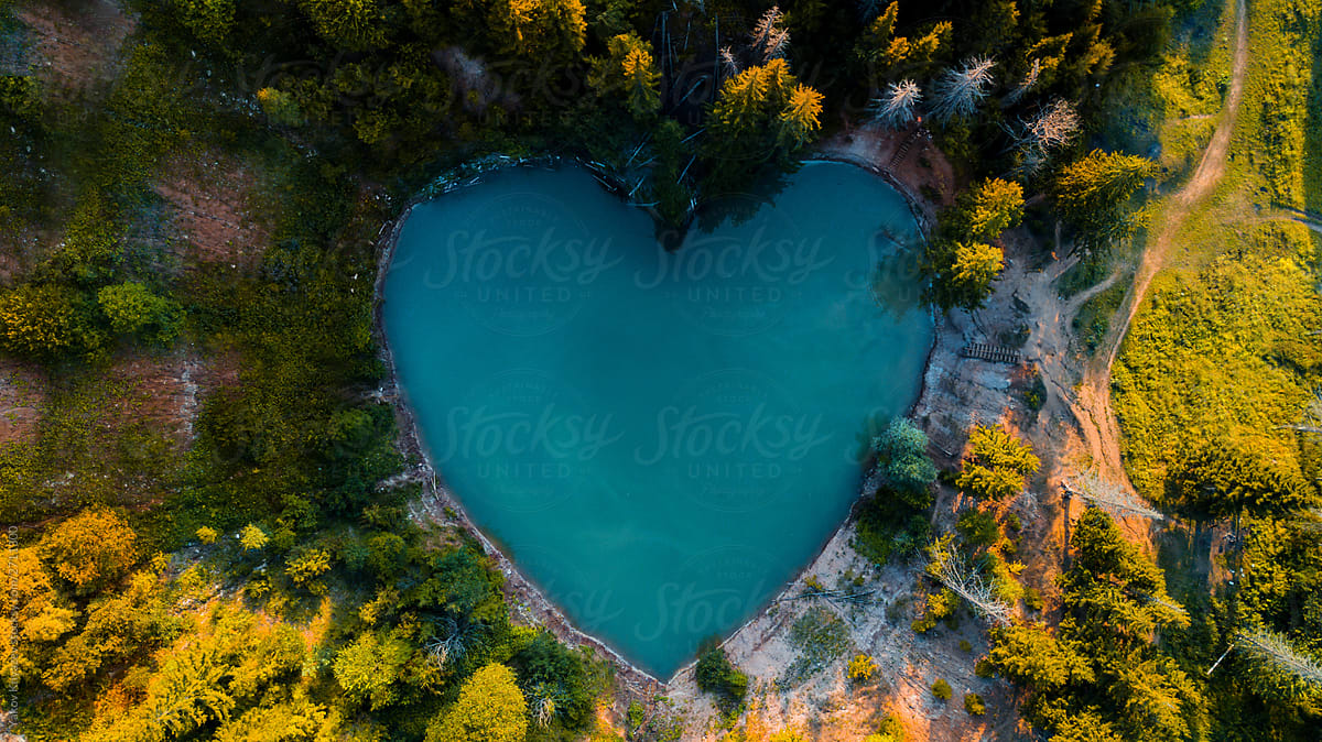 heart-shaped blue lake in the wild forest
