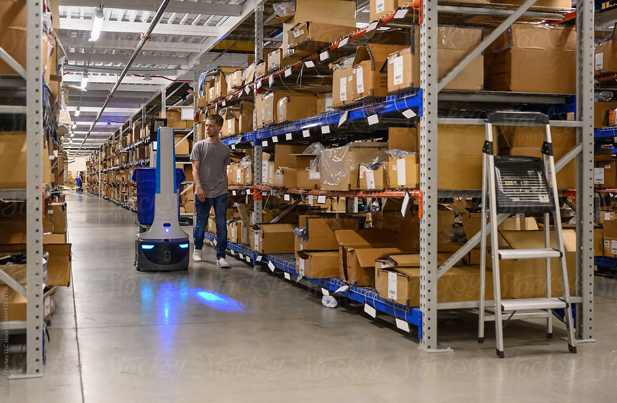Shipping Manager with Robot on floor at Warehouse