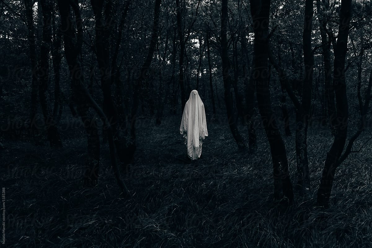 Halloween ghost in a dark forest