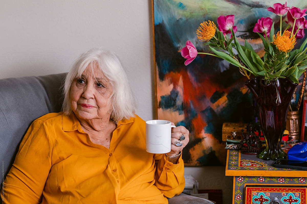 Senior woman having coffee in elderly housing apartment