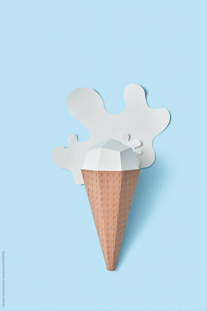 Handcraft ice-cream cone from paper in a puddle.