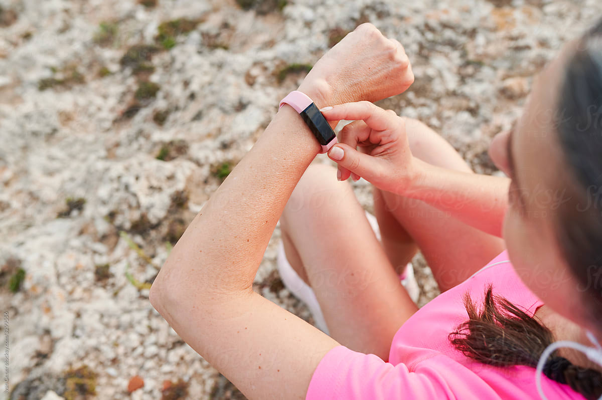 Woman syncing her watch before a run