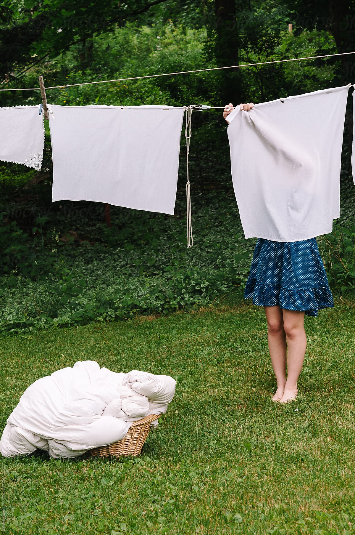 Girl hanging laundry to dry on a clothesline