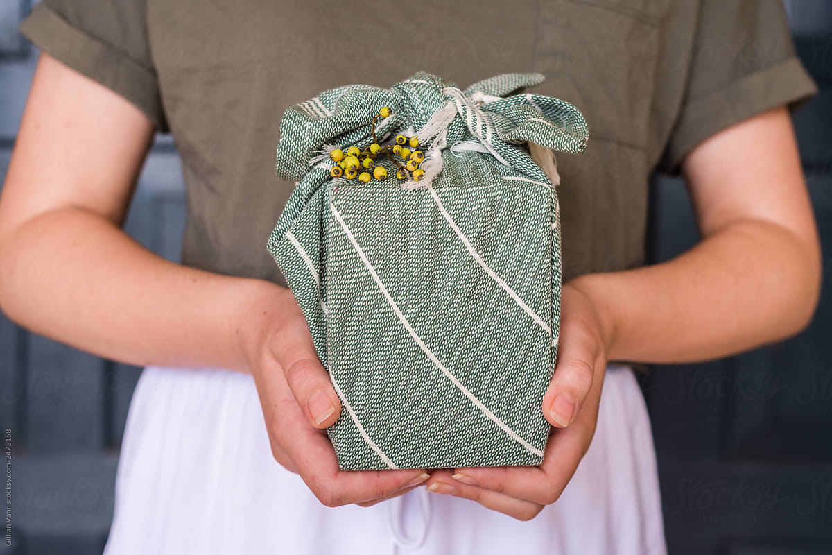 woman holding furoshiki wrapped gift