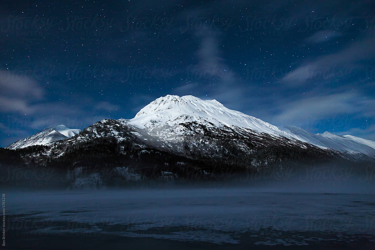 Alaska snow capped mountain with stars at night