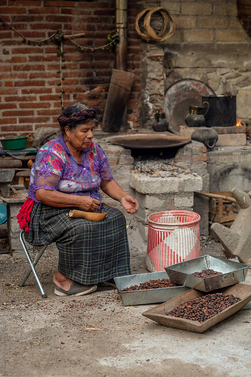 Mexican woman selecting beans for chocolate atole