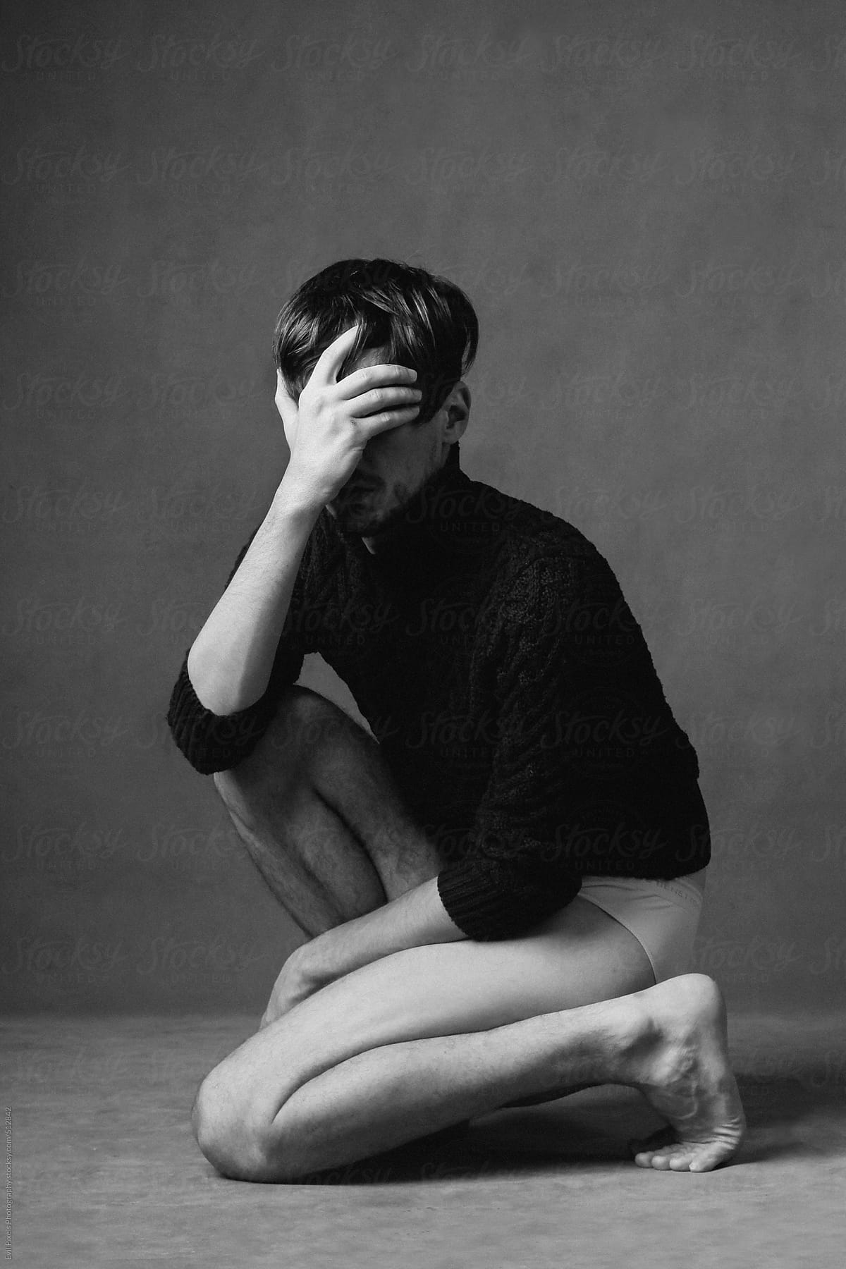 Depressed and faceless male model portrait in studio
