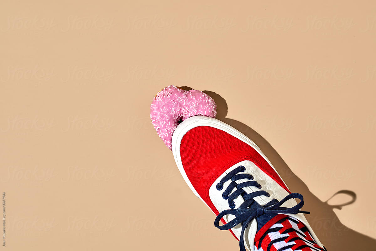 stepping on a pink heart-shaped donut