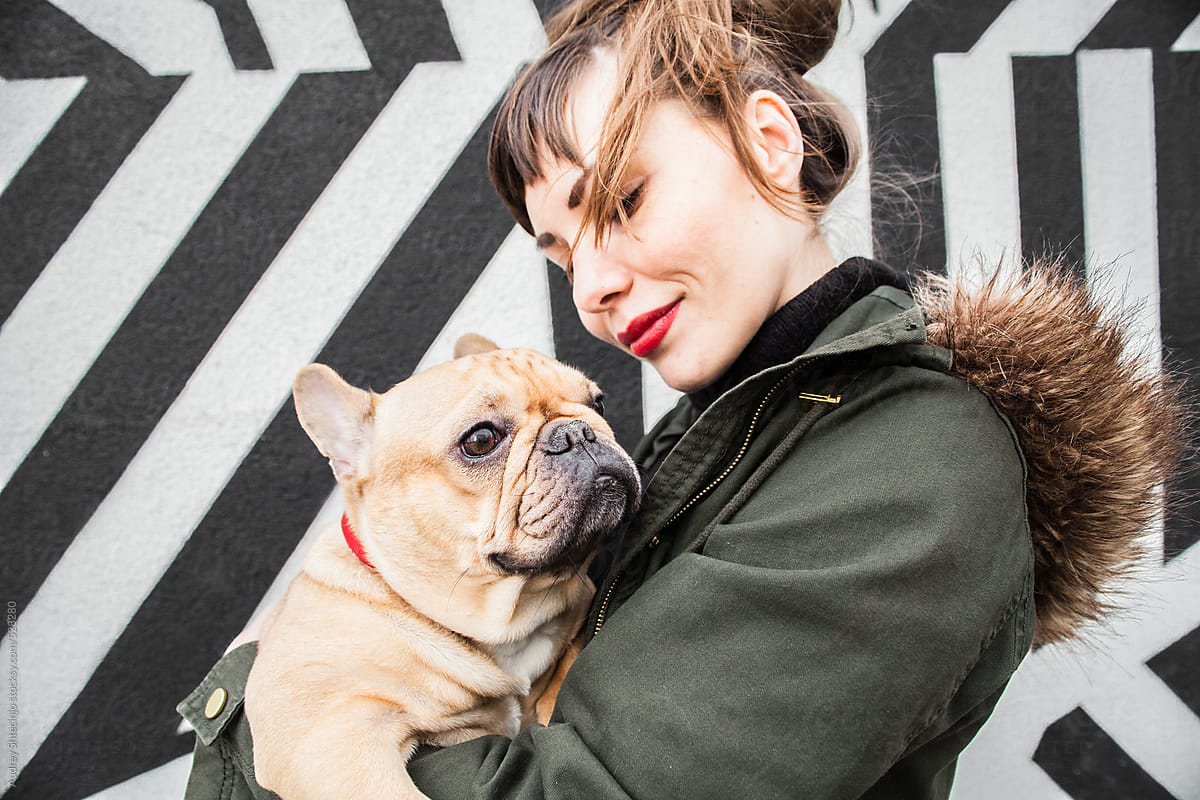 Young hip woman with french bulldog.