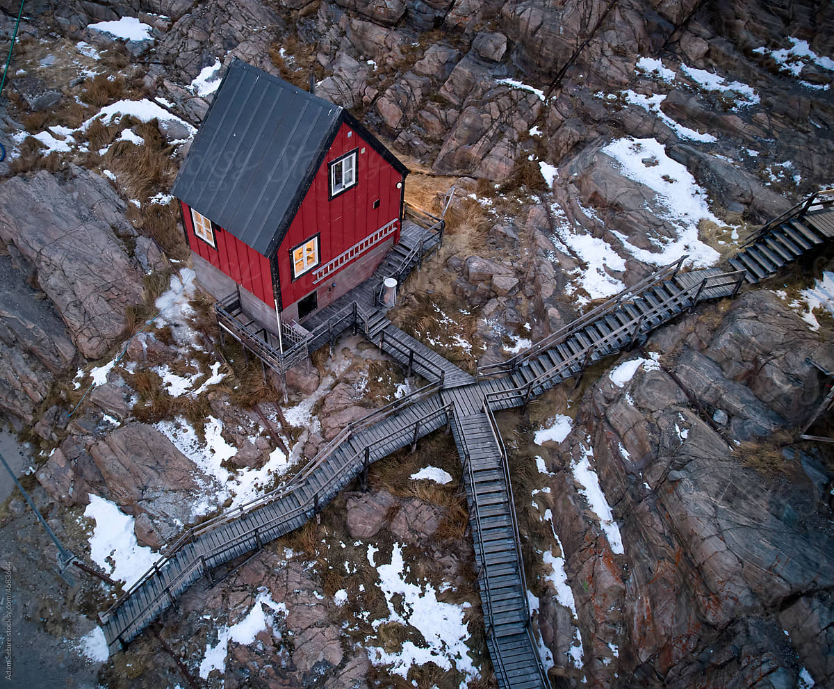 Red Greenlandic traditional tiny house lifestyle, rocky aerial view