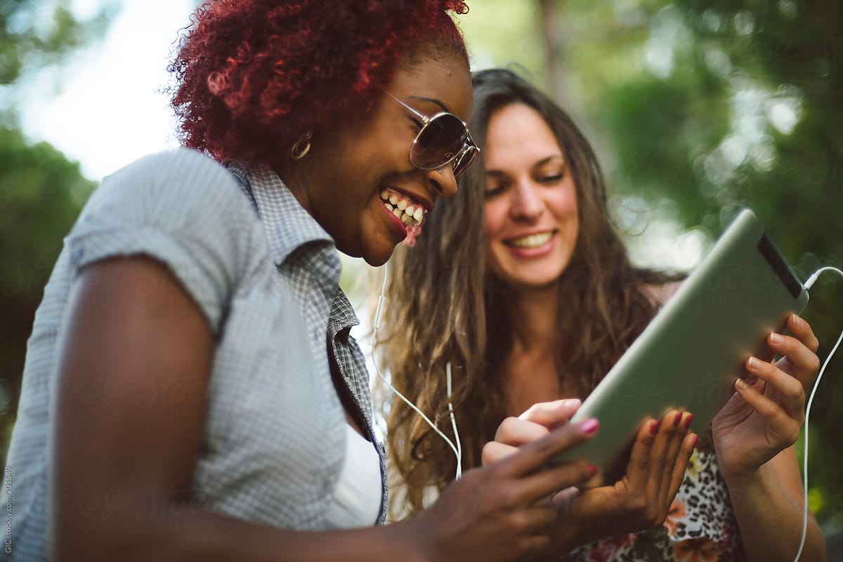 Two Female Friends Using Technology Together by Simone Wave - Woman, Friend