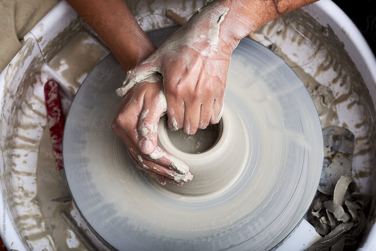 Small business Sculptor making vase on pottery wheel.