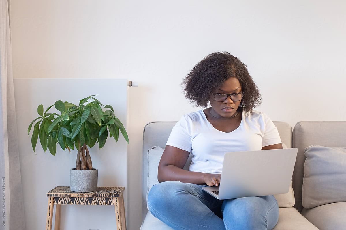 education online, black woman plus size using laptop computer at home