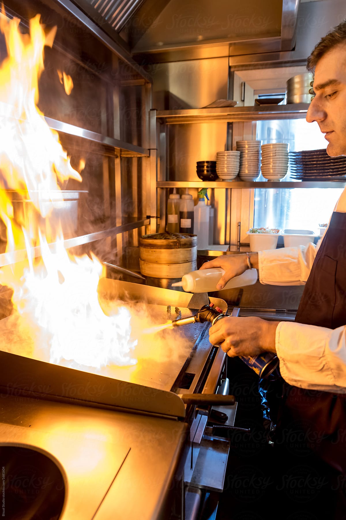 Man cooking in bright flame