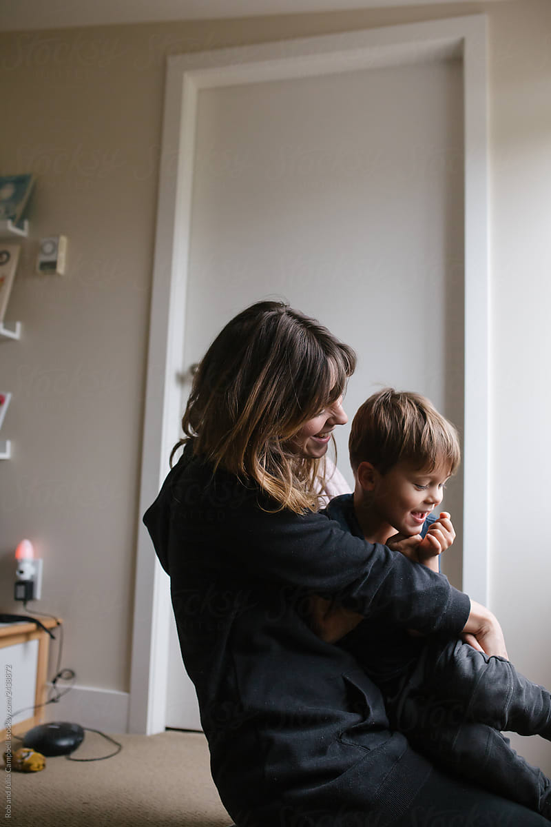 Mom And Son Enjoy A Cuddle Together At Home By Stocksy Contributor Rob And Julia Campbell 