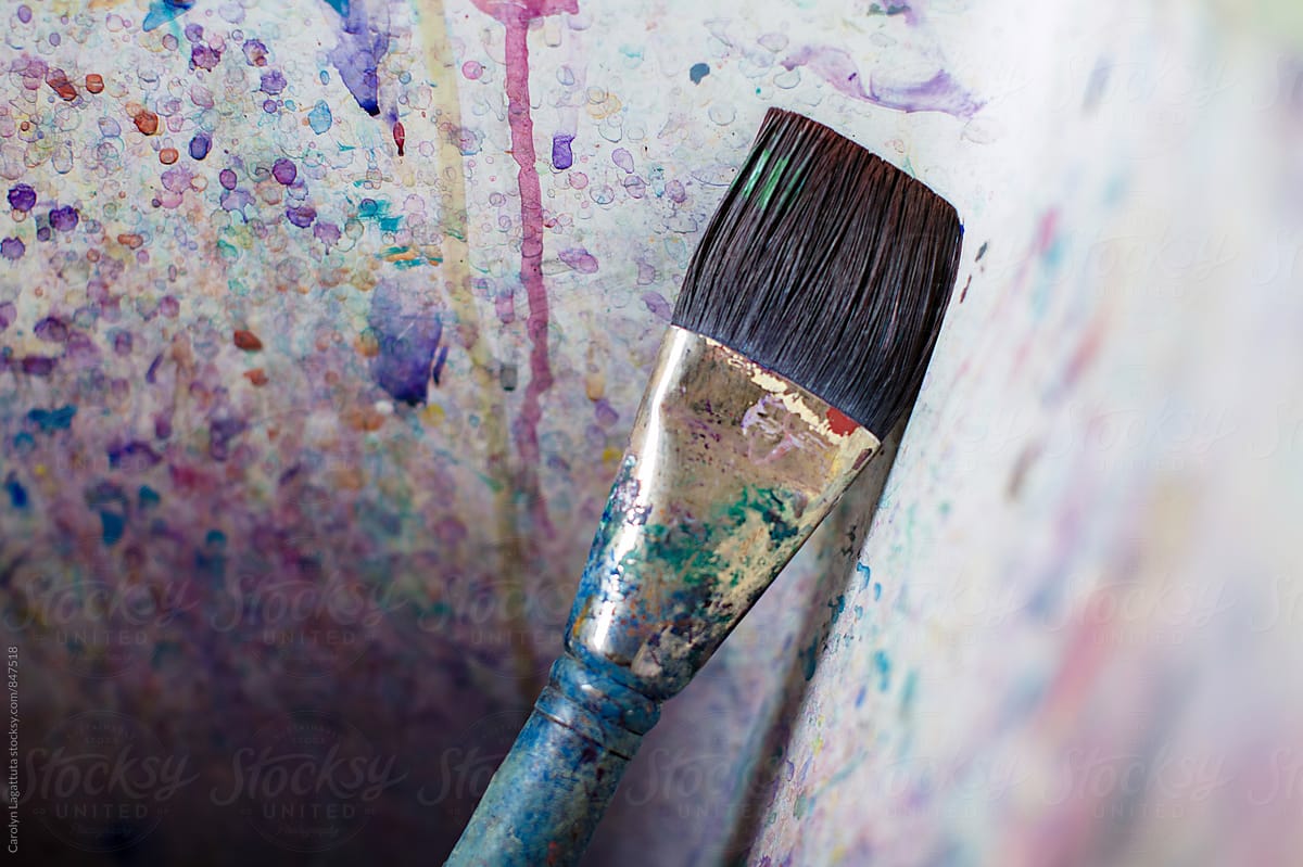 Paint brush in an artist\'s paint splattered sink