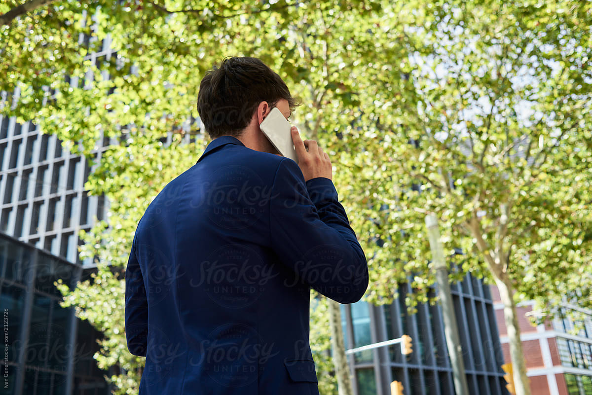 Busy businessman with smartphone