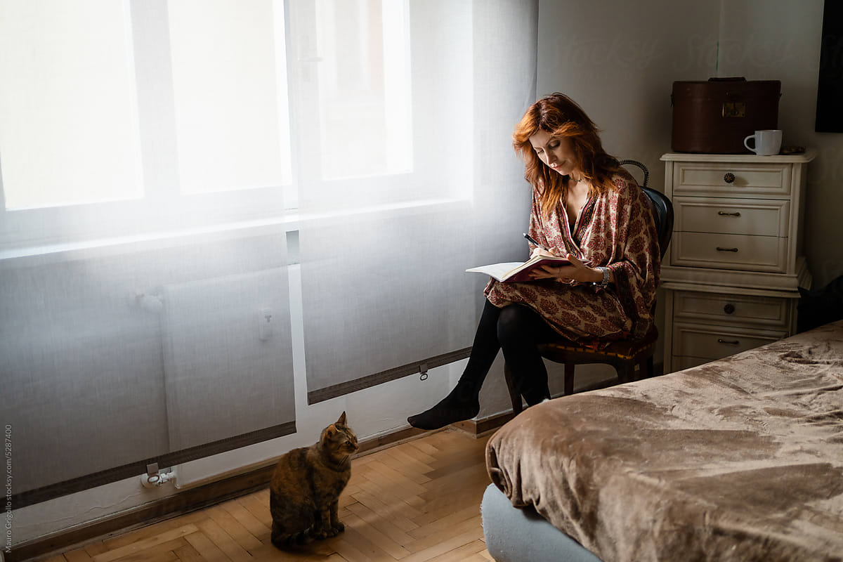 A woman reads in bedroom